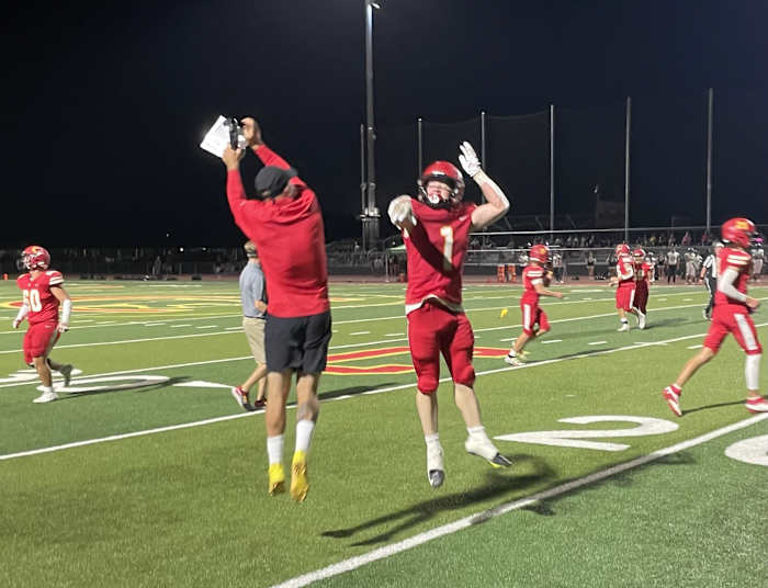 Chico's Troy Summer (1) shares a moment with a coach. Photo: Justin Couchot